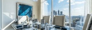 Modern dining room with city skyline view.
